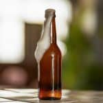 beer foam flowing out of the bottle